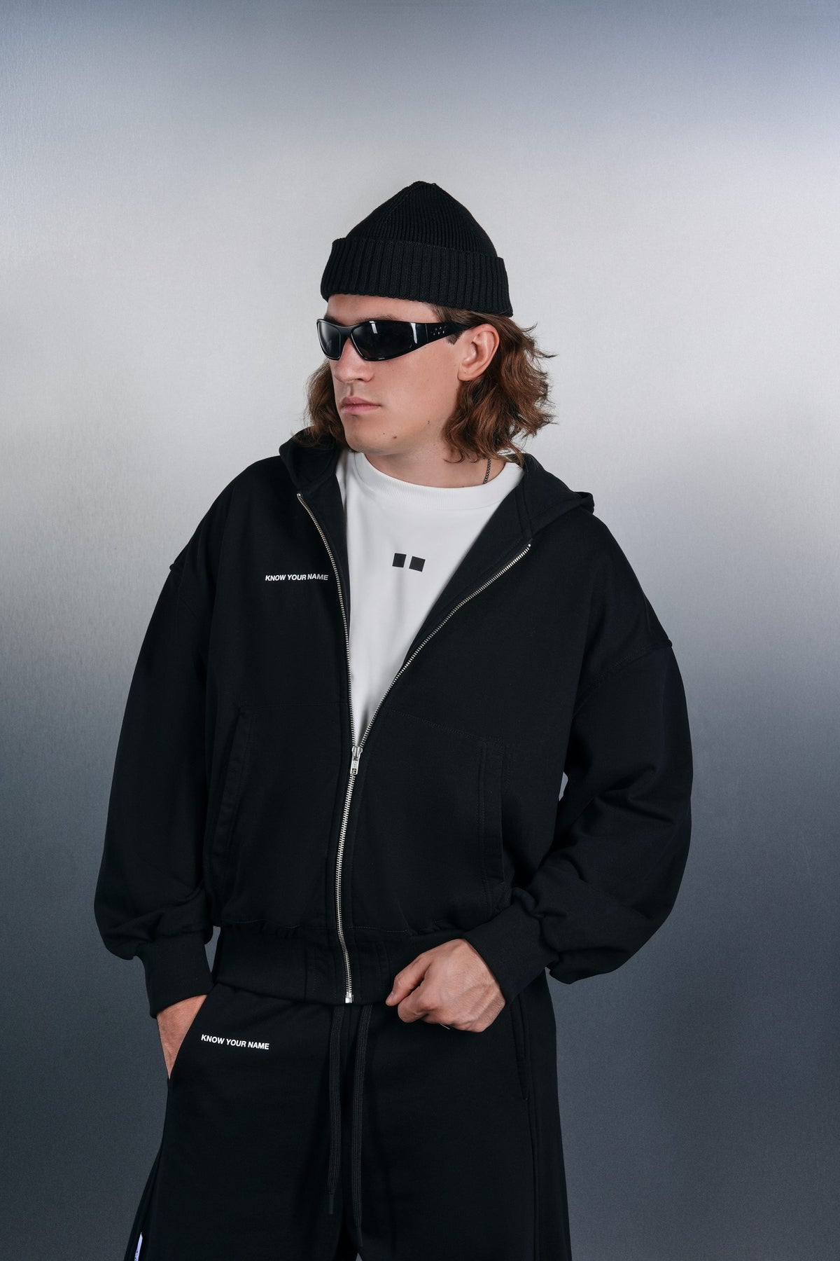 Black KYN zip hoodie over a white T-shirt