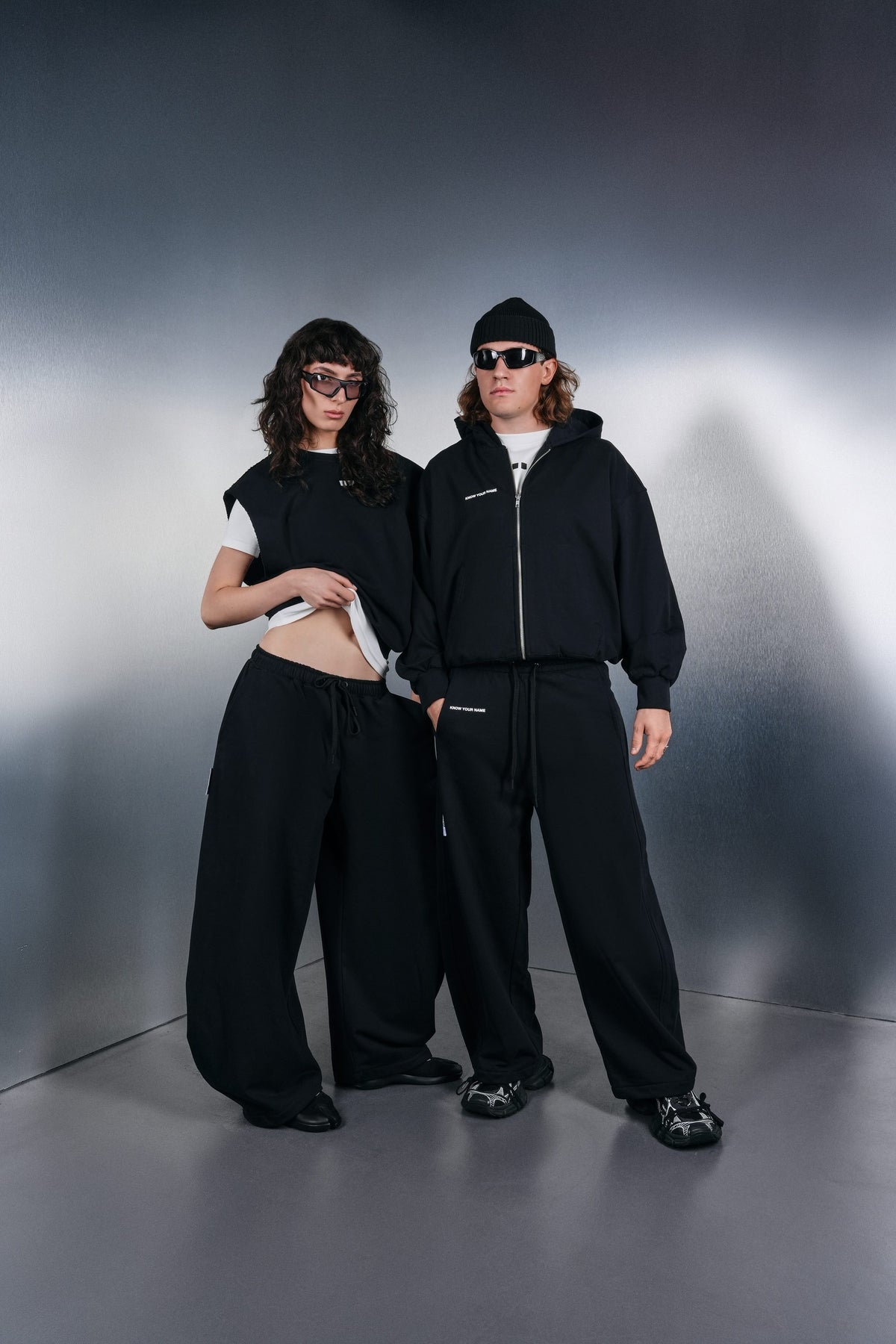 Black Drop-Shoulder vest and black KYN hoodie with black trousers