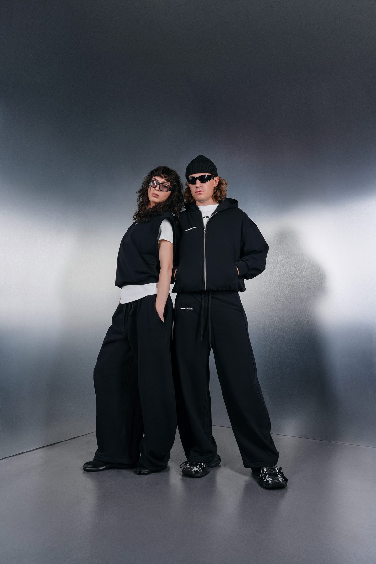 Two black KYN looks with white T-shirts underneath