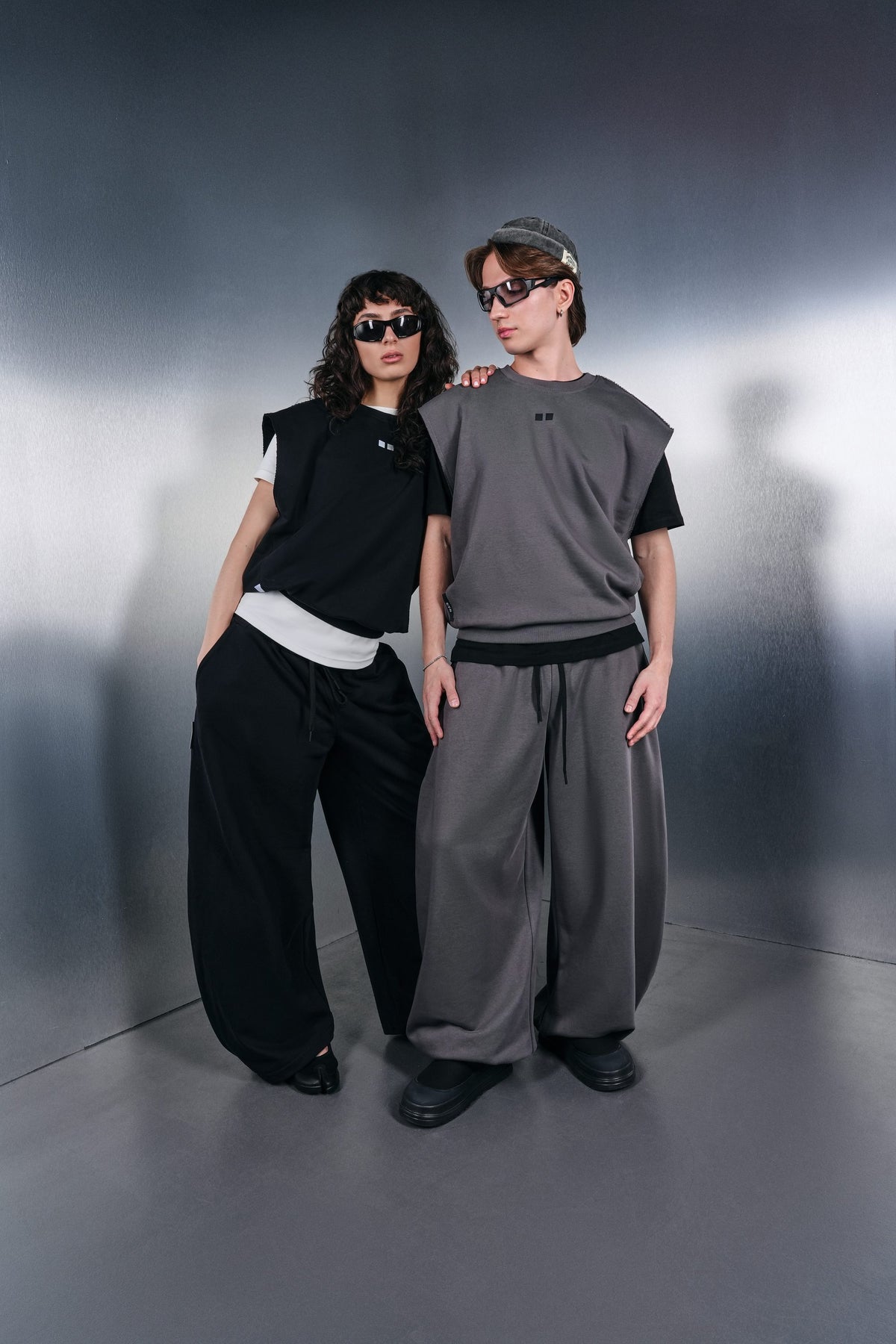 Black and grey KYN Drop-Shoulder vests with wide trousers