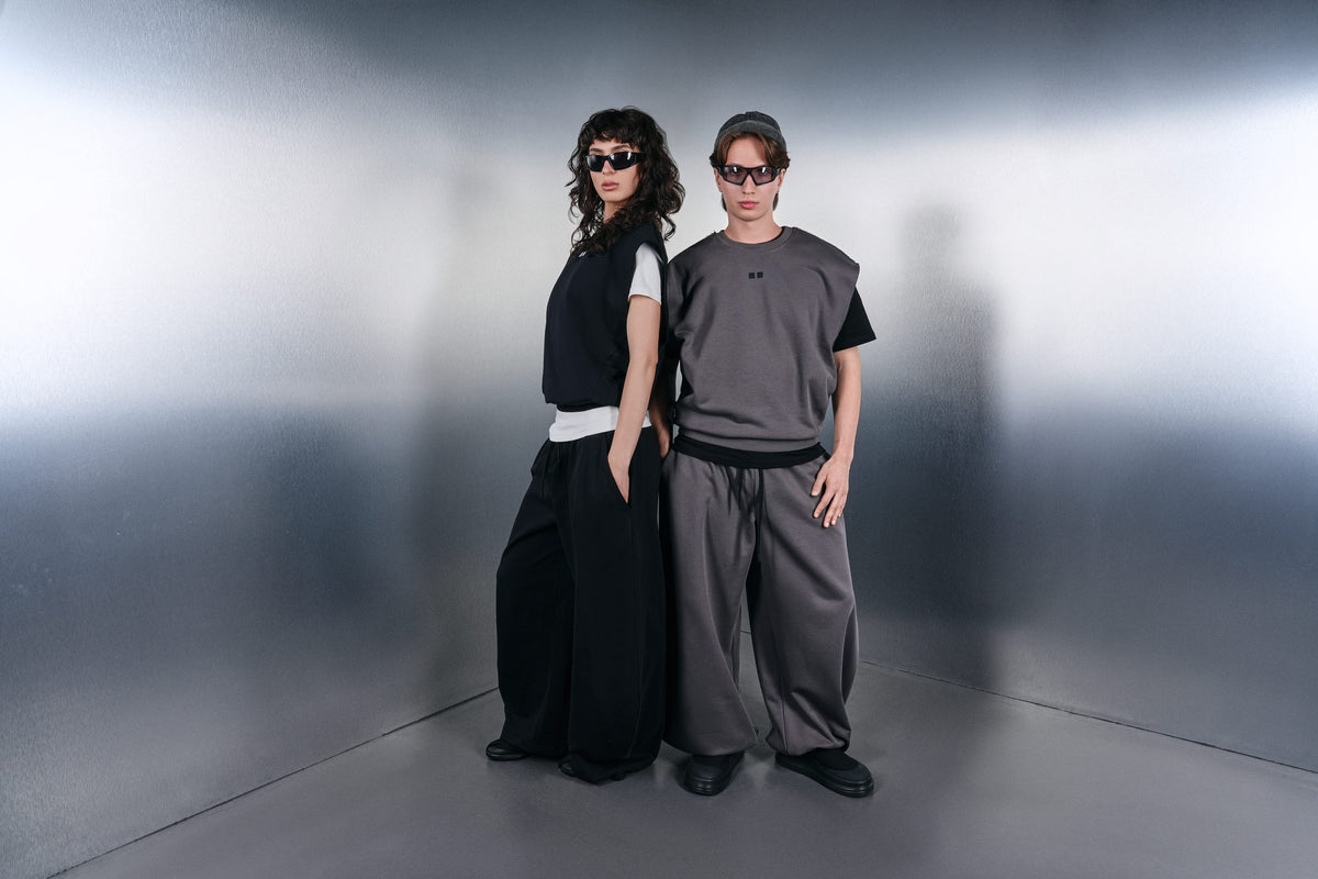 Two KYN looks: black and grey vests, wide trousers