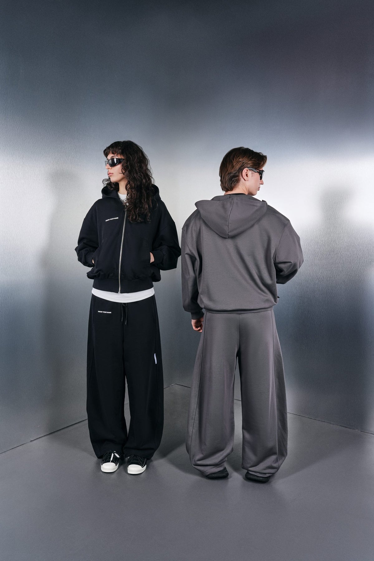 Black and grey KYN hoodies with wide trousers