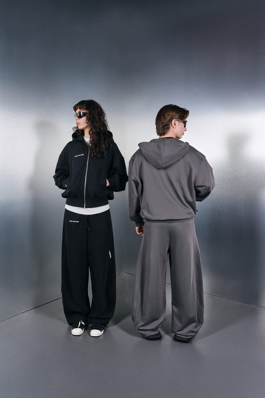 Black and grey KYN hoodies with wide trousers