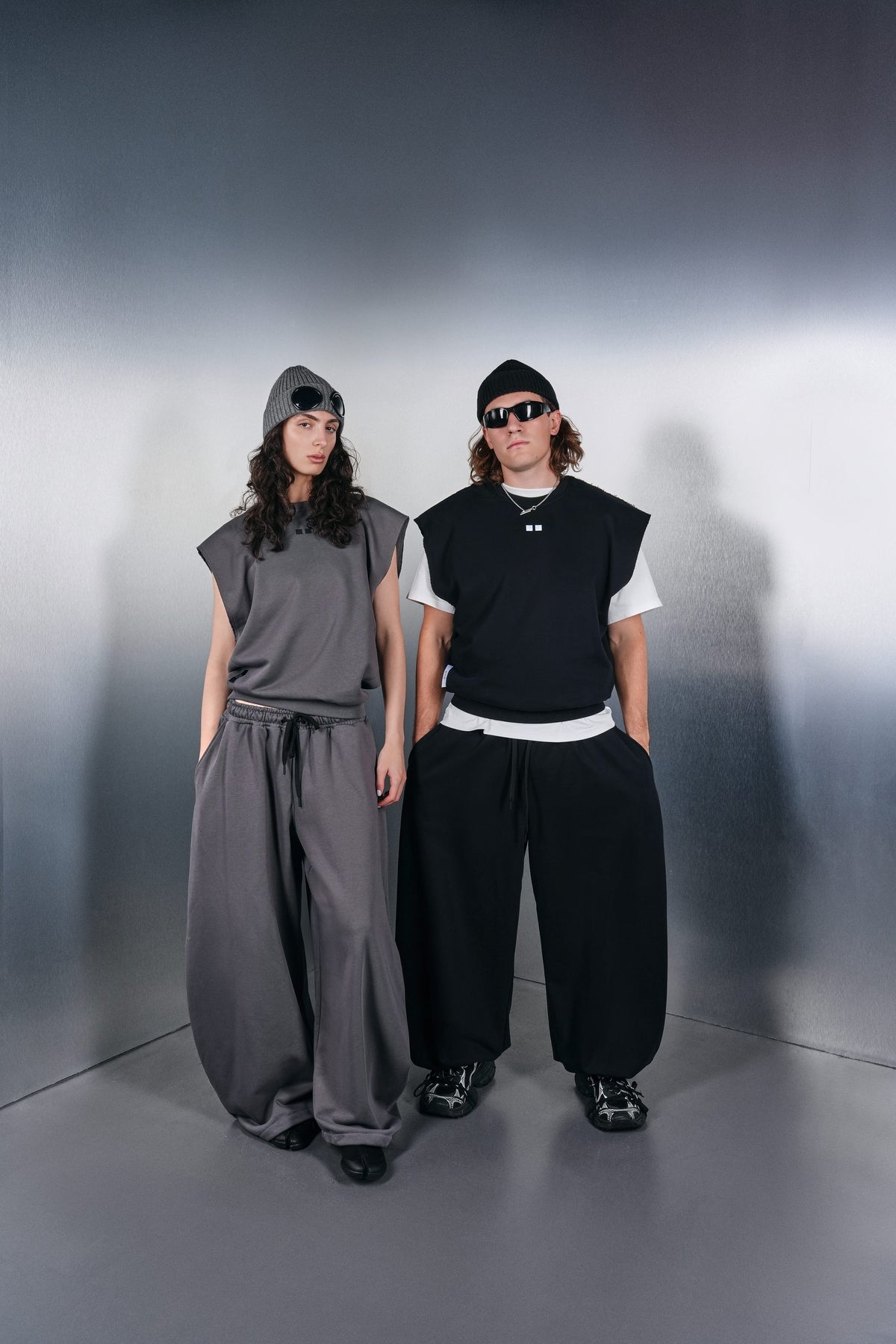 Grey and black KYN vests with wide parachute trousers